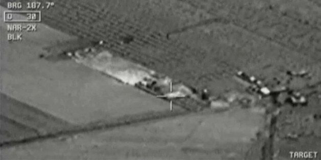 Image from aircraft cockpit video released by Turkey's state-run agency Anadolu Friday, July 24, 2015, of what they report to be Turkish warplanes striking Islamic State group targets across the border in Syria. Black object at centre above target is bomb shortly before impact. Earlier a government official said three F-16 jets took off from Diyarbakir airbase in southeast Turkey early Friday and used smart bombs to hit three IS targets across the Turkish border province from Kilis. The official, who spoke on condition of anonymity because of government rules requiring prior authorisation for comment, said the targets were two command centres and a gathering point of IS supporters. The official said the Turkish planes had not violated Syrian airspace. (Anadolu via AP Video) TURKEY OUT TV OUT