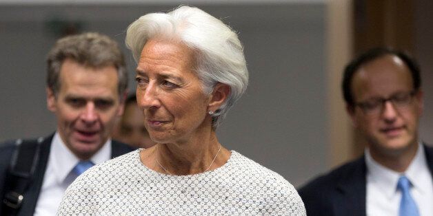 Managing Director of the International Monetary Fund Christine Lagarde, center, arrives for a meeting of eurozone finance ministers at the EU Lex building in Brussels on Saturday, July 11, 2015. Greece's negotiators head to Brussels on Saturday armed with their reform proposals and parliamentary backing to seek a third bailout, but with the shadow of severe dissent from governing lawmakers hanging over them. (AP Photo/Virginia Mayo)