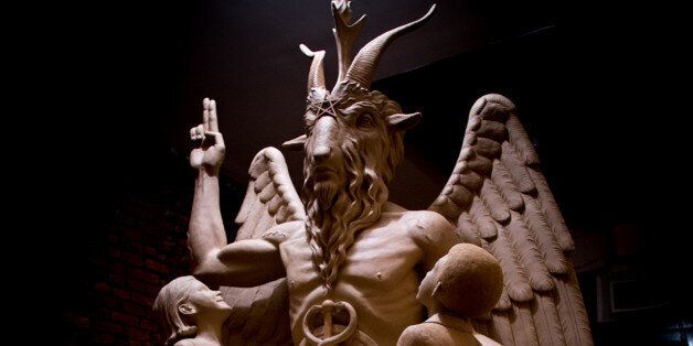 FILE - This July 6, 2015 file photo provided by The Satanic Temple shows the sculpture an 8Â½-foot-tall bronze monument featuring Satan was cast from in New York. A group plans to unveil the 1Â½-ton Baphomet, which shows Satan with horns, hooves, wings and a beard flanked by two young children, at a private event in Detroit. The Satanic Temple says it advocates the separation of church and state. (The Satanic Temple via AP, File)