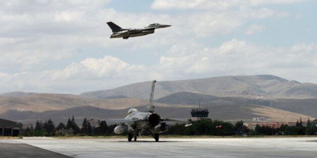 A Turkish F-16 prepares to taxi while another one takes off during Anatolian Eagle exercise at 3rd Main Jet Air Base near the central Anatolian city of Konya, Turkey, Monday, June 15, 2009. Dozens of U.S., British and Turkish pilots are engaging in mock aerial battles over central Turkey, indicating deepening relations between the allies. Pilots from Jordan and the United Arab Emirates are also participating in the exercise. (AP Photo/Selcan Hacaoglu)