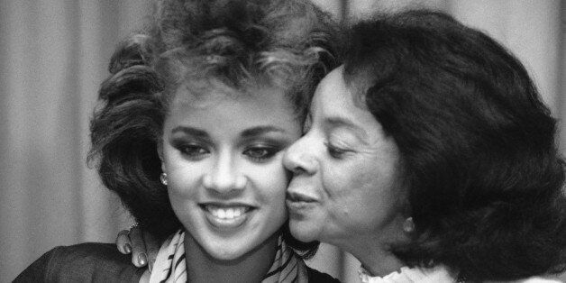 Vanessa Williams gets a supportive kiss from her mother, Helen, after Miss Williams announced she would relinquish her crown at the request of the pageant officials during a news conference in New York, Monday, July 23, 1984. Nude photographs of Miss America Williams appeared in the September issue of Penthouse magazine. (AP Photo/Marty Lederhandler)