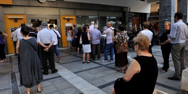 People queue at an ATM outside of a National bank branch in Thessaloniki on July 8, 2015. European leaders gave debt-stricken Athens a final deadline of Sunday to reach a new bailout deal and avoid crashing out of the euro, after Greek voters rejected international creditors' plans in a weekend referendum. Greek leaders must submit detailed reform plans by Thursday to win the fresh bailout funds the country needs to stop its banking system from collapsing, EU President Donald Tusk said after an
