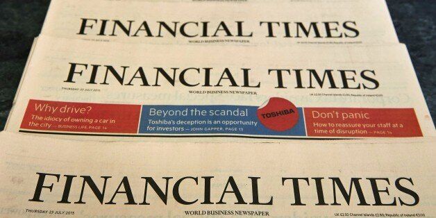 Copies of the July 23, 2015 edition of the Financial Times newspaper are displayed for a photograph in London on July 23, 2015. British publisher Pearson revealed today it is in 'advanced' talks to sell its flagship business newspaper the Financial Times to an unnamed suitor. AFP PHOTO / NIKLAS HALLE'N (Photo credit should read NIKLAS HALLE'N/AFP/Getty Images)