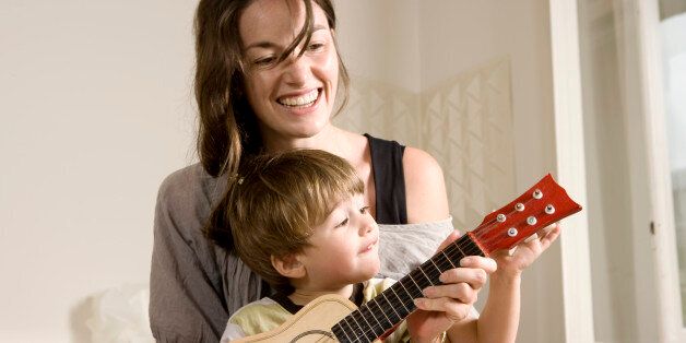 Little Boy and his Mother Playing Guitar