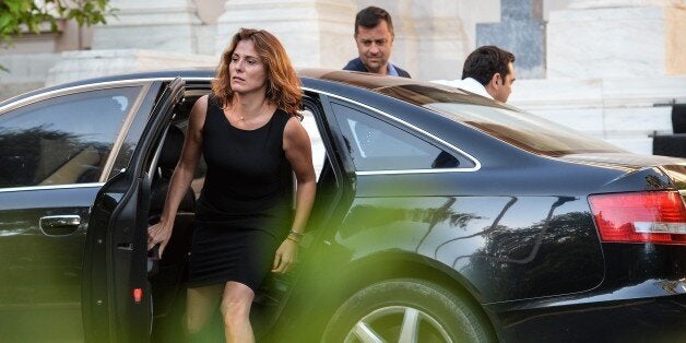 Greek Prime Minister Alexis Tsipras (R) arrives with his wife Betty Baziana, at prime minister's office, in downtown Athens on July 5, 2015. Greek voters headed to the polls on July 5 to vote in a historic, tightly-fought referendum on whether to accept worsening austerity measures in exchange for more bailout funds, in a gamble that could see the country crash out of the euro. AFP PHOTO / ANDREAS SOLARO (Photo credit should read ANDREAS SOLARO/AFP/Getty Images)