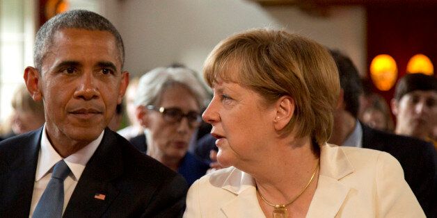German Chancellor Angela Merkel, right, speaks with U.S. President Barack Obama during a concert at the G-7 summit at Schloss Elmau hotel near Garmisch-Partenkirchen, southern Germany, Sunday, June 7, 2015. The two-day summit will address such issues as climate change, poverty and the situation in Ukraine. (AP Photo/Virginia Mayo, Pool)