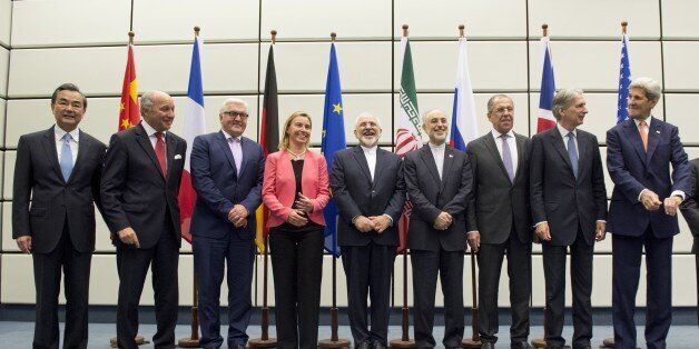 (From L to R) Chinese Foreign Minister Wang Yi, French Foreign Minister Laurent Fabius, German Foreign Minister Frank-Walter Steinmeier, European Union High Representative for Foreign Affairs and Security Policy Federica Mogherini, Iranian Foreign Minister Mohammad Javad Zarif, Head of the Iranian Atomic Energy Organization Ali Akbar Salehi, Russian Foreign Minister Sergey Lavrov, British Foreign Secretary Philip Hammond, US Secretary of State John Kerry and US Secretary of Energy Ernest Moniz pose for a group picture at the United Nations building in Vienna, Austria July 14, 2015. Iran and six major world powers reached a nuclear deal, capping more than a decade of on-off negotiations with an agreement that could potentially transform the Middle East, and which Israel called an 'historic surrender'. AFP PHOTO / POOL / JOE KLAMAR (Photo credit should read JOE KLAMAR/AFP/Getty Images)