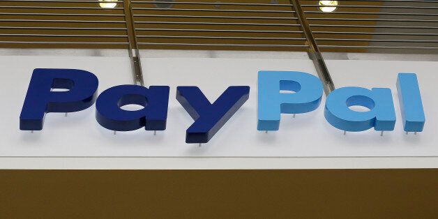 This March 10, 2015 photo shows a PayPal sign inside the main entrance to an office building in San Jose, Calif. (AP Photo/Jeff Chiu)