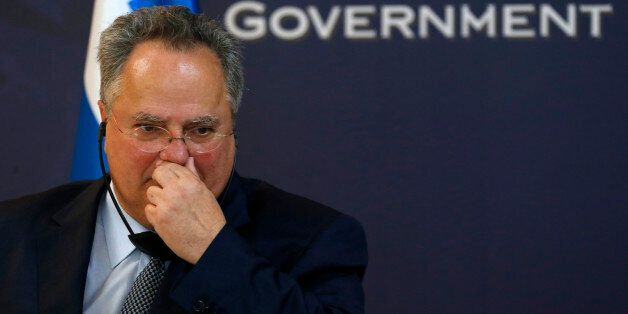 Greek Foreign Minister Nikos Kotzias listens questions during a press conference after talks with Ivica Dacic, Serbia's Foreign Minister and Organization for Security and Co-operation in Europe (OSCE) Chairperson-in-office for 2015, unseen, in Belgrade, Serbia, Thursday, June 25, 2015. Kotzias is on a one-day visit to meet with Serbian officials. (AP Photo/Darko Vojinovic)