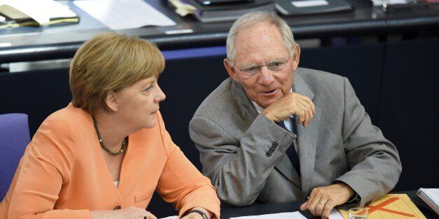 German Finance Minister Wolfgang Schaeuble (R) and German Chancellor Angela Merkel attend a session at the Bundestag lower house of parliament on the Greek crisis on July 1, 2015 in Berlin. German Chancellor Angela Merkel said that 'the future of Europe is not at stake' because of the crisis over Greece after the breakdown of debt talks and expiry of its aid programme. AFP PHOTO / ODD ANDERSEN (Photo credit should read ODD ANDERSEN/AFP/Getty Images)