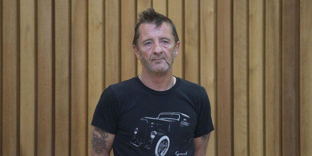 Former AC/DC drummer Phil Rudd stands in the dock as faces charges at the High Court in Tauranga, New Zealand on November 26, 2014. The 60-year-old Australian, who has lived in Tauranga for over 30 years, hit the headlines on November 6 when he appeared in court accused of attempting to hire a hitman to kill two people, as well as the charges he still faces. The more serious charge of attempting to procure murder that police laid was dropped the day after his first court appearance, Crown Solicitor Greg Hollister-Jones having decided there was insufficient evidence. AFP PHOTO / MARTY MELVILLE (Photo credit should read Marty Melville/AFP/Getty Images)