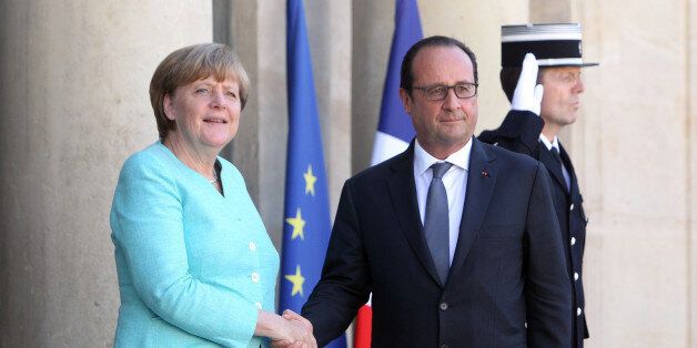 France's President Francois Hollande, right, and German chancellor Angela Merkel shake hands prior to a meeting, at the Elysee Palace, in Paris, France, Monday, July 6, 2015. German Chancellor Angela Merkel has arrived at the Elysee Palace for talks with French President Francois Hollande about the Greek crisis. The two are expected to issue a joint statement that's likely to reflect the line to be taken at the summit. France has appeared more conciliatory than Germany toward Greece over the pas