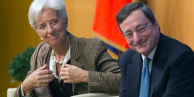 Managing Director of the International Monetary Fund Christine Lagarde, left, and European Central Bank President Mario Draghi, right, smile during a panel on