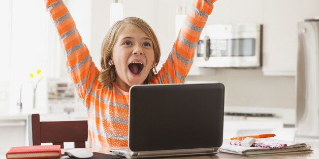 USA, Utah, Lehi, Excited girl (6-7) with laptop