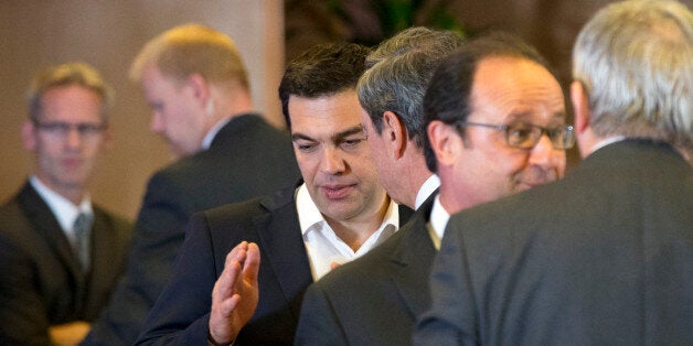 Greek Prime Minister Alexis Tsipras, center left, speaks with European Central Bank Governor Mario Draghi, center right, during a round table meeting at an emergency summit of eurozone heads of state and government at the EU Council building in Brussels on Tuesday, July 7, 2015. Greek Prime Minister Alexis Tsipras on Tuesday will try to use a resounding referendum victory to eke out concessions from European creditors over a bailout for the crisis-ridden country. (AP Photo/Michel Euler)