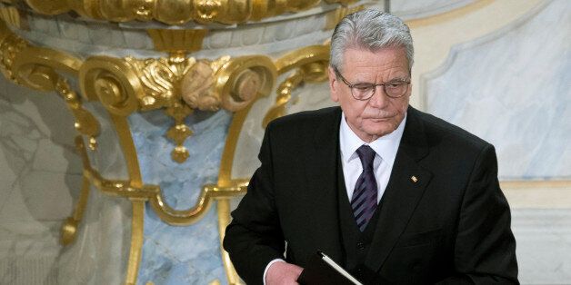 German President Joachim Gauck leaves the podium after delivering a speech during a memorial service at the Frauenkirche cathedral (Church of Our Lady) commemorating the 70th anniversary of the deadly allied bombing of Dresden during WWII, in Dresden, eastern Germany, Friday, Feb. 13, 2015. British and U.S. bombers on Feb. 13 to 14, 1945 destroyed Dresden's centuries-old baroque city center. (AP Photo/Jens Meyer)