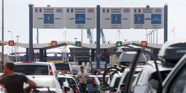Ferry passengers heading to England line up at the car ferry terminal in Calais, northern France, Monday, June 29, 2015. French ferry workers angry over possible job losses are disrupting the port of Calais and traffic across the English Channel. The workers for MyFerryLink resumed their protest Monday angered by a court ruling about the future of the company. (AP Photo/Michel Spingler)