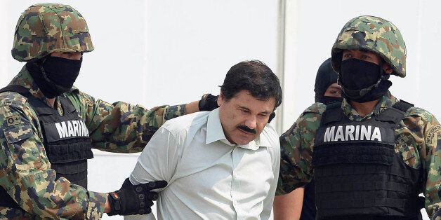 Mexican drug trafficker Joaquin Guzman Loera aka 'el Chapo Guzman' (C), is escorted by marines as he is presented to the press on February 22, 2014 in Mexico City. The Sinaloa cartel leader - the most wanted by US and Mexican anti-drug agencies - was arrested early this morning by Mexican marines at a resort in Mazatlan, northern Mexico. AFP PHOTO/Alfredo Estrella (Photo credit should read ALFREDO ESTRELLA/AFP/Getty Images)