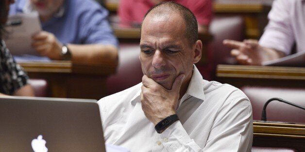 Former Greek Finance Minister Yianis Varoufakis reacts while reading a document on a laptop during a parliamentary group meeting at the Greek Parliament in Athens on July 10, 2015. Lawmakers in Greece are to vote whether to back a last-ditch reform plan the government submitted to creditors overnight in a bid to stave off financial collapse and exit from the eurozone. AFP PHOTO / LOUISA GOULIAMAKI (Photo credit should read LOUISA GOULIAMAKI/AFP/Getty Images)