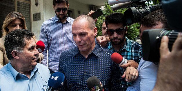 Outgoing Greek Finance Minister Yanis Varoufakis is surrounded by media as he leaves from his house in Athens, Monday, July 6, 2015. Varoufakis resigned Monday, saying he was told shortly after Greece's decisive referendum result that some other eurozone finance ministers and the country's other creditors would appreciate his not attending the ministers' meetings. (Giorgos Bampoukos/InTime News via AP) GREECE OUT