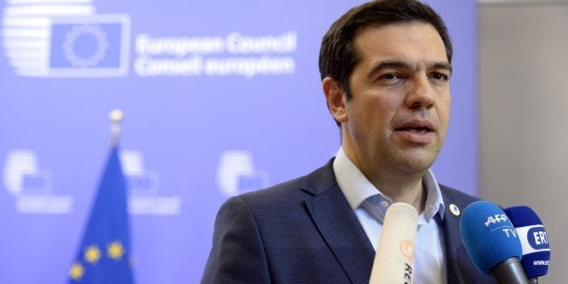 Greek Prime Minister Alexis Tsipras talks to the media at the end of an Eurozone Summit over the Greek debt crisis in Brussels on July 13, 2015. Juncker said there was no longer any risk of Greece crashing out of the euro after Athens agreed a bailout deal with eurozone partners. AFP PHOTO / THIERRY CHARLIER (Photo credit should read THIERRY CHARLIER/AFP/Getty Images)