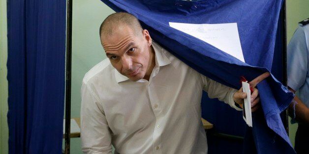 Greece's Finance Minister Yanis Varoufakis casts his vote at a polling station in Athens, Sunday, July 5, 2015. Greeks were voting Sunday in a bailout referendum that will decide the country's future, with opinion polls showing people evenly split on whether to accept creditors' proposals for more austerity in exchange for rescue loans or defiantly reject the deal. (AP Photo/Petr David Josek)