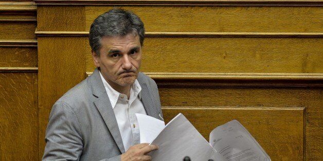 Greek Finance Minister Euclid Tsakalotos delivers a speech during a parliamentary session at the Greek Parliament in Athens on July 10, 2015. Greece's international creditors believe its latest debt proposals are positive enough to be the basis for a new bailout worth 74 billion euros, an EU source said June 10. AFP PHOTO/ANDREAS SOLARO (Photo credit should read ANDREAS SOLARO/AFP/Getty Images)