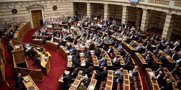 Greek Lawmakers attend an emergency Parliament session for the governmentâs proposed referendum in Athens on Saturday, June 27, 2015. Germany's vice chancellor says that a Greek referendum on the bailout talks could in principle make sense, but notes that it should be clear to voters what they will be deciding on.(AP Photo/Petros Giannakouris)