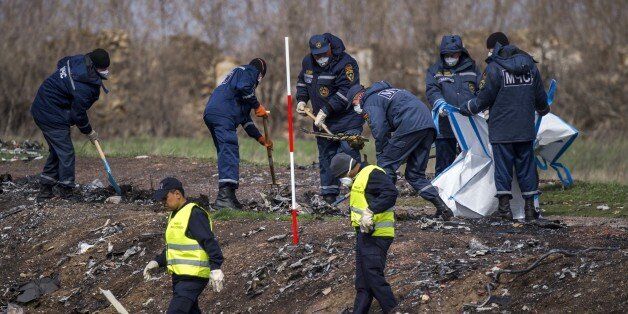 Dutch and Malaysian investigators and local authorities work, on April 16, 2015 at the MH17 plane crash site near the village of Grabove in the self-proclaimed Donetsk People's Republic (DNR) as Dutch and international investigators are renewing their search for body parts and debris in restive eastern Ukraine, including at a location previously considered unsafe, the team's chief announced on the eve. All 298 passengers and crew onboard the Malaysia Airlines jetliner -- the majority of them Dutch -- died when it was shot down over war-torn eastern Ukraine last year. AFP PHOTO / ODD ANDERSEN (Photo credit should read ODD ANDERSEN/AFP/Getty Images)