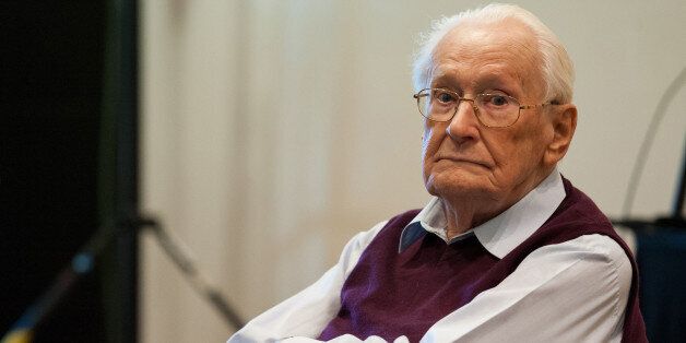 Former SS guard Oskar Groening waits for the start of the trial against him in Lueneburg, northern Germany, Wednesday, April 29, 2015. 93-years-old Groening faces 300,000 counts of accessory to murder at the trial, which will test the argument that anyone who served as a guard at a Nazi death camp was complicit in what happened there. (Philipp Schulze/Pool Photo via AP)