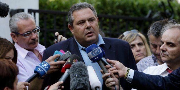 Greek Defense Minister Panos Kammenos, who heads the government's junior coalition member Independent Greeks, makes statements after his meeting with Greek Prime Minister Alexis Tsipras at Maximos Mansion in Athens, Monday, July 13, 2015. After months of acrimony, Greece clinched a preliminary bailout agreement with its European creditors on Monday that will, if implemented, secure the country's place in the euro and help it avoid financial collapse. (AP Photo/Petros Karadjias)