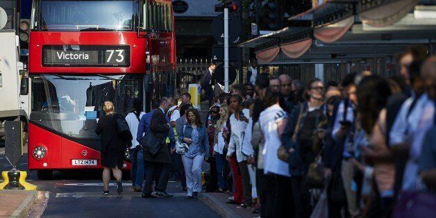 Early morning commuters form queues to board buses at Victoria station during a tube strike in London on July 9, 2015. London's roads, buses and overland trains struggled to cope in Thursday's morning rush hour as commuters battled into work in the face of London Underground's first strike shutdown since 2002. AFP PHOTO / NIKLAS HALLE'N (Photo credit should read NIKLAS HALLE'N/AFP/Getty Images)