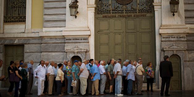 Pensioners wait outside the main gate of the national bank of Greece to withdraw a maximum of 120 euros ($134) in central Athens, Friday, July 10, 2015. Greece's Prime Minister Alexis Tsipras will seek backing for a harsh new austerity package from his party Friday to keep his country in the euro â less than a week after urging Greeks to reject milder cuts in a referendum. (AP Photo/Emilio Morenatti)