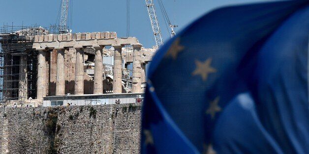 A European Union flag waves in front of the ancient temple of Parthenon atop the Acropolis hill in Athens on July 7, 2015. Eurozone leaders will hold an emergency summit in Brussels on July 7 to discuss the fallout from Greek voters' defiant 'No' to further austerity measures, with the country's Prime Minister Alexis Tsipras set to unveil new proposals for talks. AFP PHOTO /ARIS MESSINIS (Photo credit should read ARIS MESSINIS/AFP/Getty Images)