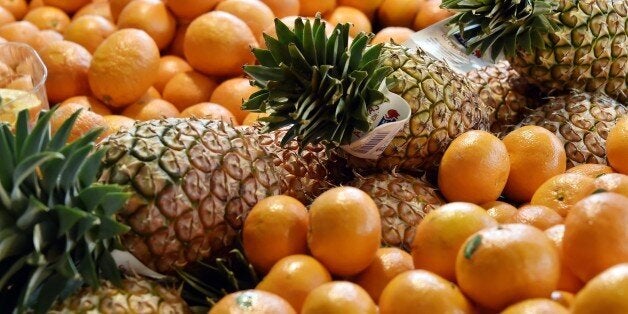 A picture taken on April 15, 2015 shows clementines, oranges and pineapples on display at the Talensac market in central Nantes, western France. /AFP PHOTO GEORGES GOBET (Photo credit should read GEORGES GOBET/AFP/Getty Images)