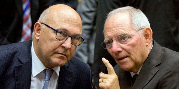 German Finance Minister Wolfgang Schaeuble, right, speaks with French Finance Minister Michel Sapin during a round table meeting of eurogroup finance ministers at the EU Lex building in Brussels on Sunday, July 12, 2015. Greece has another chance Sunday to convince skeptical European creditors that it can be trusted to enact wide-ranging economic reforms which would safeguard its future in the common euro currency. (AP Photo/Virginia Mayo)