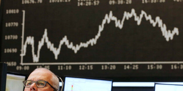 A trader watches his screens at the stock market in Frankfurt, Germany, Wednesday, July 8, 2015. (AP Photo/Michael Probst)