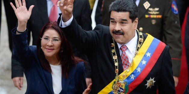 Venezuelan President Nicolas Maduro (R) and his wife Cilia Flores (L) wave upon their arrival at the National Assembly for a session commemorating Independence Day in Caracas on July 5, 2015. AFP PHOTO/FEDERICO PARRA (Photo credit should read FEDERICO PARRA/AFP/Getty Images)