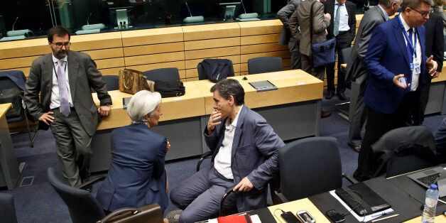 Greek Finance Minister Euclid Tsakalotos. center right, speaks with Managing Director of the International Monetary Fund Christine Lagarde, center left, during a round table meeting of eurogroup finance ministers at the EU Lex building in Brussels on Sunday, July 12, 2015. Greece has another chance Sunday to convince skeptical European creditors that it can be trusted to enact wide-ranging economic reforms which would safeguard its future in the common euro currency. (AP Photo/Michel Euler)
