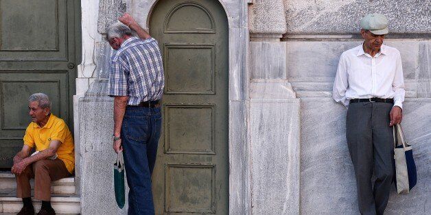 Pensioners wait outside a national bank of Greece to receive their benefits, limited to another 120 euro, on July 9, 2015 in Athens. Greece was to submit a detailed bailout request to its EU partners in the eurozone Thursday in a last-ditch effort to save its collapsing economy and its membership in the European single currency.. AFP PHOTO/ LOUISA GOULIAMAKI (Photo credit should read LOUISA GOULIAMAKI/AFP/Getty Images)