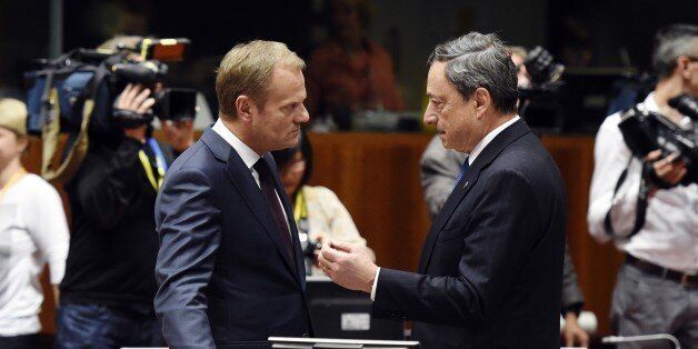 European Council president Donald Tusk (L), talks with European central bank president Mario Draghi, before a round table meeting as part on an EU summit at the EU headquarters in Brussels on June 25, 2015. Talks between eurozone finance ministers broke up without agreeing on a Greek debt deal, with a new meeting due in coming days, Finland's Alexander Stubb said. AFP PHOTO/ ALAIN JOCARD (Photo credit should read ALAIN JOCARD/AFP/Getty Images)