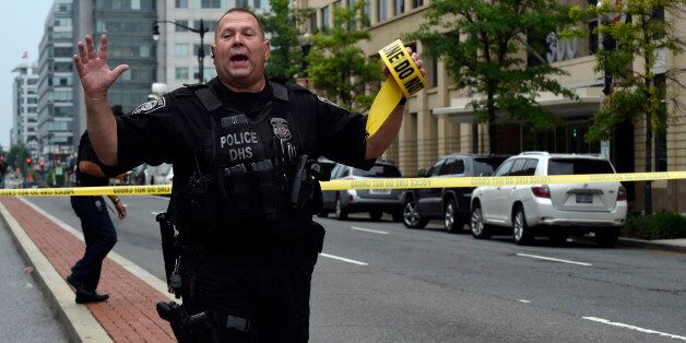 Police tell members of the media to move near the Washington Navy Yard in Washington, Thursday, July 2, 2015. A lockdown was underway Thursday morning across the Washington Navy Yard campus after reports of shots fired, but a senior law enforcement official said those reports had not been confirmed. (AP Photo/Susan Walsh)