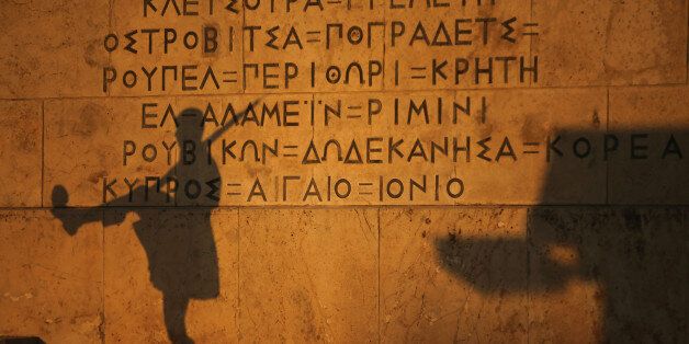 ATHENS, GREECE - JULY 13: The shadow of a Greek Presidental Evzoni guard falls on the parliament building as protesters gather to demonstrate against austerity after an agreement for a third bailout with eurozone leaders on July 13, 2015 in Athens, Greece. The bailout is conditional on Greece passing agreed reforms in parliament by Wednesday which includes streamlining pensions and rasing more raise tax revenue. (Photo by Christopher Furlong/Getty Images)