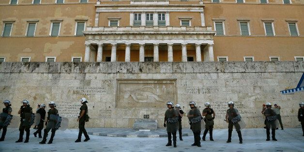Riot police stand guard during a bailout protest in front of the Tomb of the Unknown Soldier in front of the parliament in central Athens, Thursday, June 25, 2015. EU leaders met in Brussels for an EU summit to discuss, among other issues, migration and the Greek bailout. (AP Photo/Petros Karadjias)