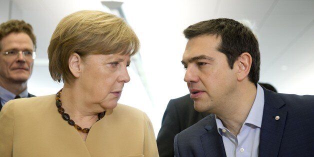 German chancellor Angela Merkel (L) talks with Greek prime minister Alexis Tsipras at the begining of...
