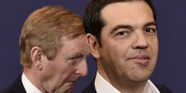 Irish Prime minister Enda Kenny (L) and Greek Prime Minister Alexis Tsipras look on following a family photo during a European Union summit at the EU headquarters in Brussels on April 23, 2015. AFP PHOTO / JOHN THYS (Photo credit should read JOHN THYS/AFP/Getty Images)