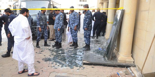 Security forces work at the site of a deadly blast claimed by the Islamic State group that struck worshippers attending Friday prayers at a Shiite mosque in Kuwait City, Friday, June 26, 2015. Friday's explosion struck the Imam Sadiq Mosque in the neighborhood of al-Sawabir, a residential and shopping district of the capital. (AP Photo)