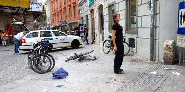 A danaged bicycle and bloodstains are pictured at the site where a man drove his van into a crowd in Graz, southern Austria, Saturday, June 20, 2015. Police confirmed the incident but would not give any details or confirm the number of dead and injured persons. (Elmar Gubisch/APA via AP)