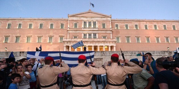 Presidental guards make their way through gathered crowds during a pro-European demonstration in front of the Greek parliament in Athens on June 22, 2015. Greece's international lenders raised hopes for a vital bailout agreement this week to save Athens from default and a possible euro exit, despite warning no deal was likely at an emergency summit. AFP PHOTO / LOUISA GOULIAMAKI (Photo credit should read LOUISA GOULIAMAKI/AFP/Getty Images)