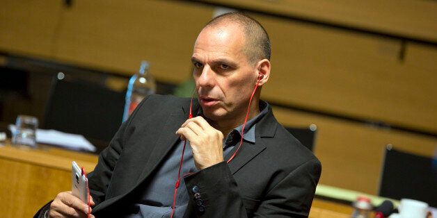 Greek Finance Minister Yanis Varoufakis uses a phone as he waits for the start of a round table of EU finance ministers at the European Council building in Luxembourg on Friday, June 19, 2015. Europe was scrambling Friday to pick up the pieces after another failed meeting over Greeceâs bailout that reinforced fears that the country was heading for bankruptcy and a possible euro exit. (AP Photo/Virginia Mayo)